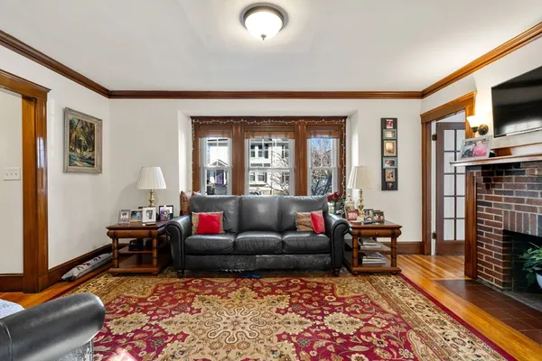 a living room with furniture fireplace and flat screen tv