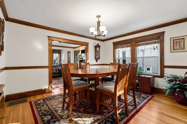 a view of a dining room with furniture window and wooden floor
