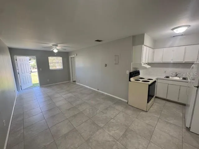 a view of a kitchen with cabinets and stainless steel appliances