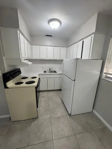 a kitchen with a cabinets and a stove top oven
