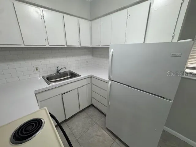 a kitchen with a refrigerator and cabinets