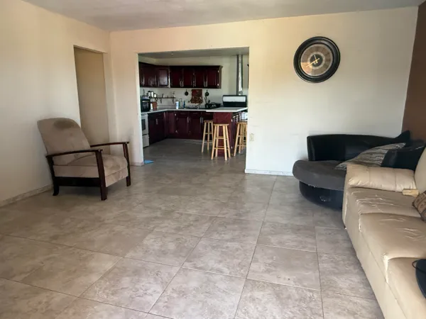 a living room with furniture and a clock