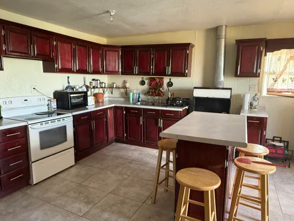 a kitchen with a stove a sink dishwasher and a microwave oven with wooden cabinets