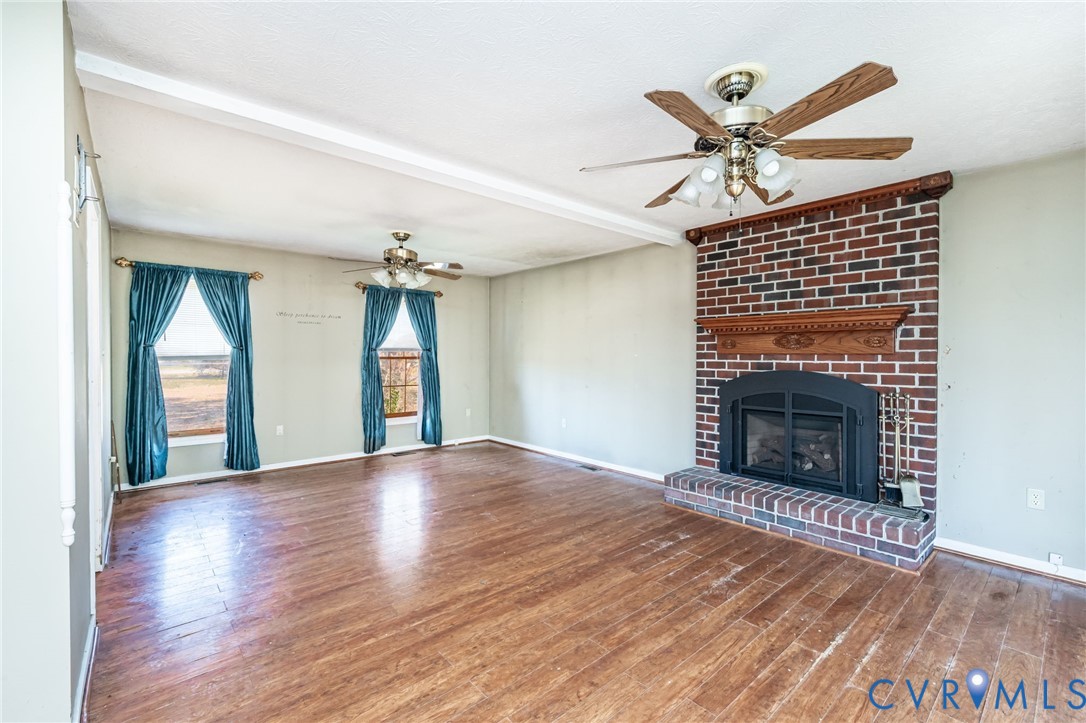 8910 Tunstall Road New Kent, VA 23124 - Photo 15 of 45 Unfurnished living room featuring ceiling fan, woo