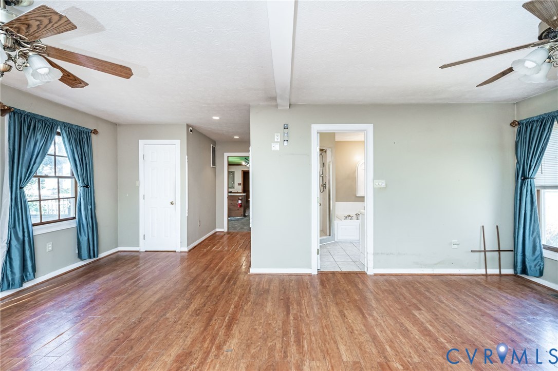 8910 Tunstall Road New Kent, VA 23124 - Photo 17 of 45 Unfurnished living room with a ceiling fan, plenty