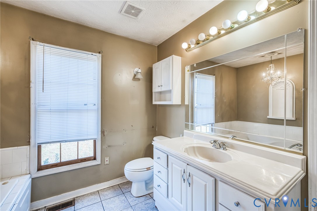 8910 Tunstall Road New Kent, VA 23124 - Photo 19 of 45 Bathroom featuring vanity, light tile patterned fl