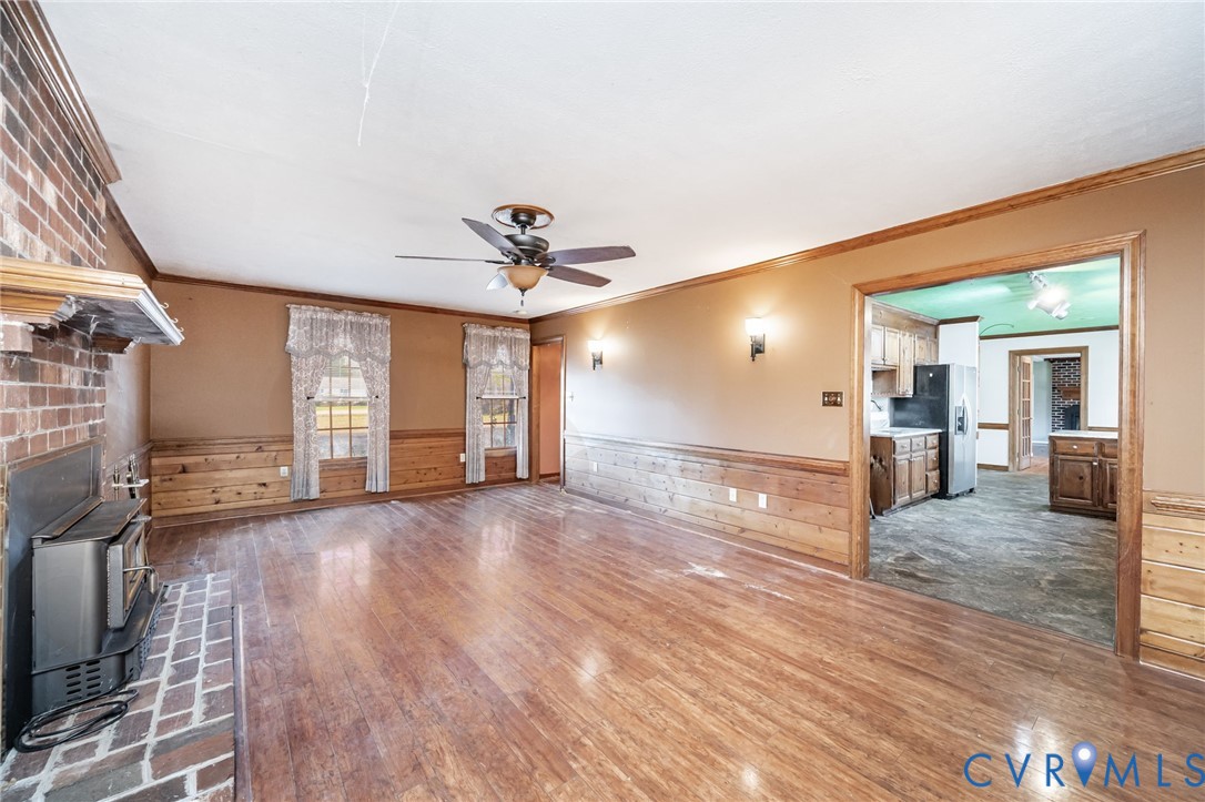 8910 Tunstall Road New Kent, VA 23124 - Photo 21 of 45 Unfurnished living room featuring a wainscoted wal