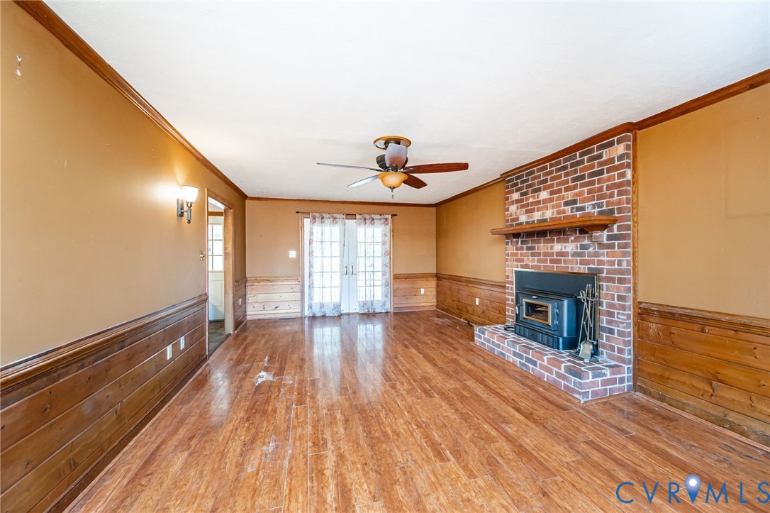 8910 Tunstall Road New Kent, VA 23124 - Photo 22 of 45 Unfurnished living room with wainscoting, ornament