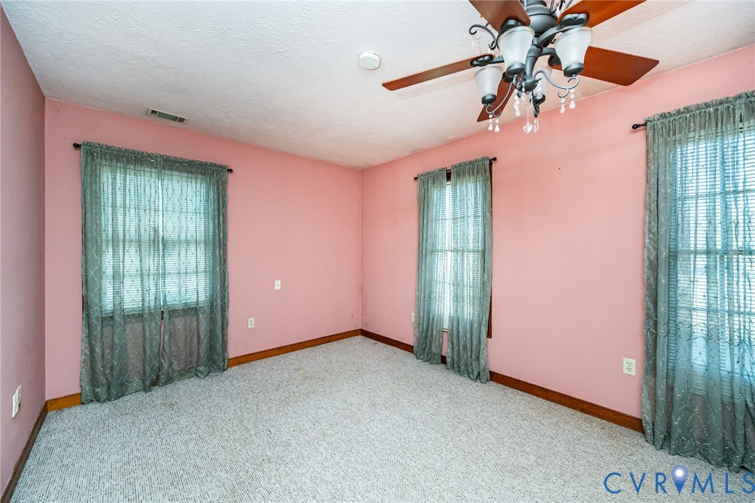 8910 Tunstall Road New Kent, VA 23124 - Photo 23 of 45 Carpeted spare room with a textured ceiling and ce