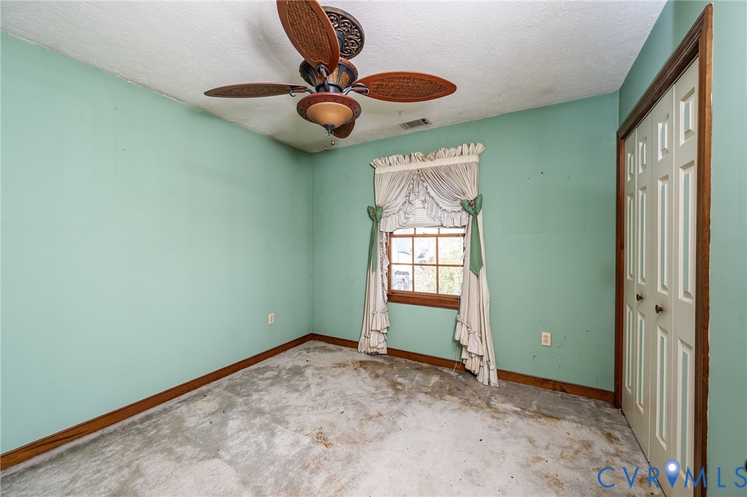 8910 Tunstall Road New Kent, VA 23124 - Photo 25 of 45 Unfurnished bedroom featuring a closet, a textured