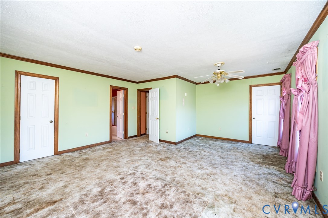 8910 Tunstall Road New Kent, VA 23124 - Photo 28 of 45 Unfurnished bedroom featuring ornamental molding a