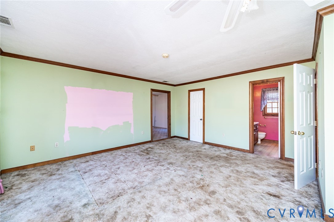 8910 Tunstall Road New Kent, VA 23124 - Photo 29 of 45 Unfurnished bedroom featuring crown molding, carpe