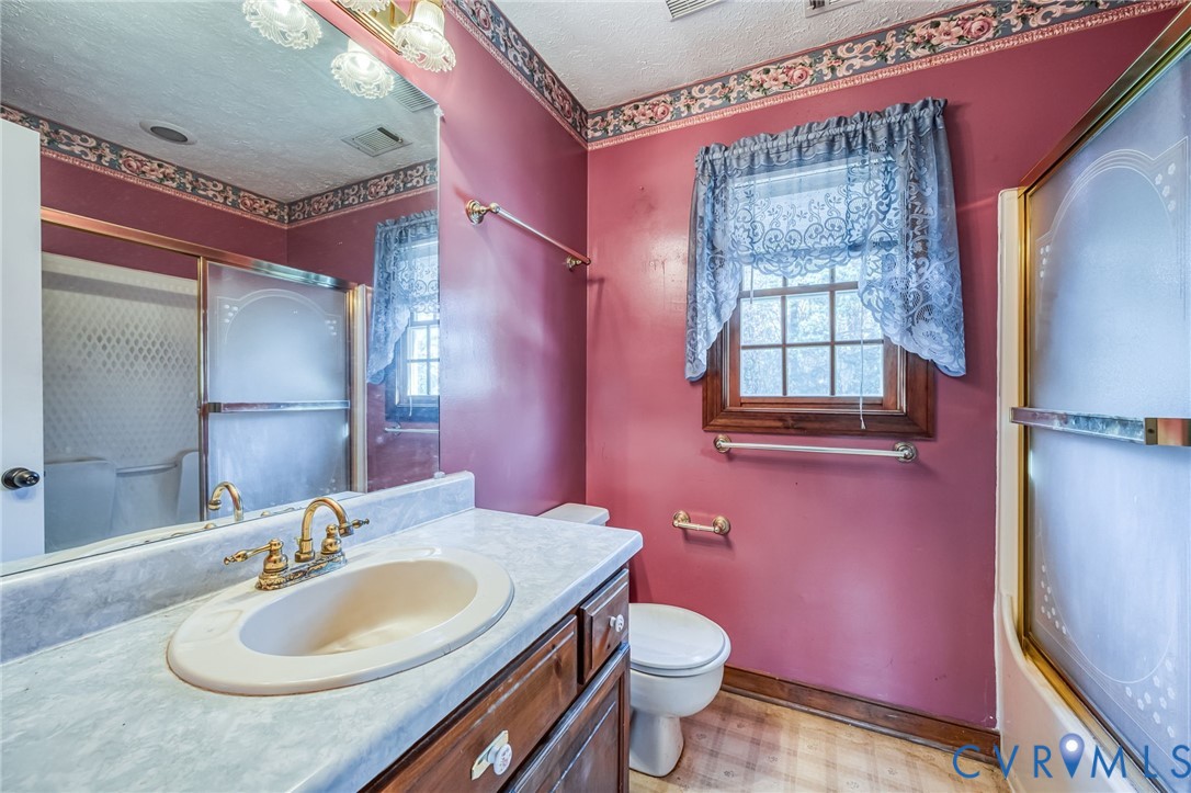 8910 Tunstall Road New Kent, VA 23124 - Photo 32 of 45 Full bath with a textured ceiling, vanity, bath /