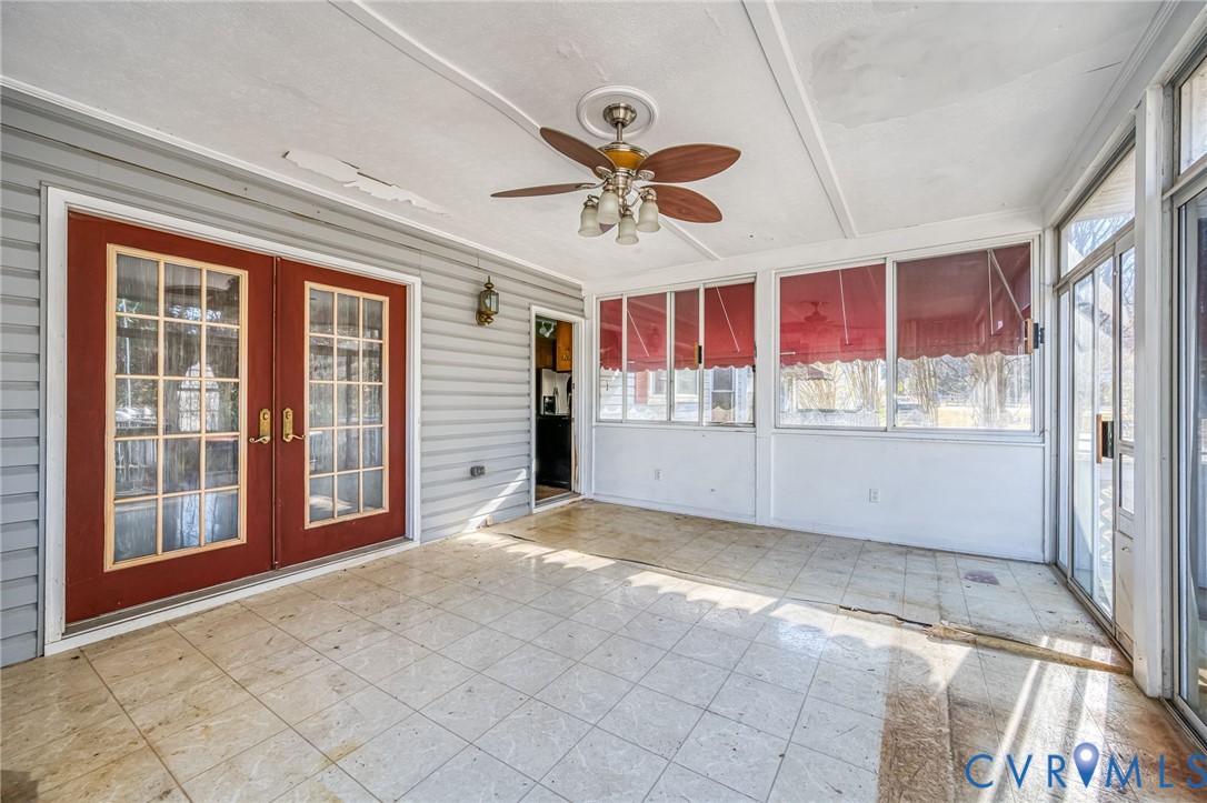 8910 Tunstall Road New Kent, VA 23124 - Photo 36 of 45 Unfurnished sunroom with ceiling fan and french do