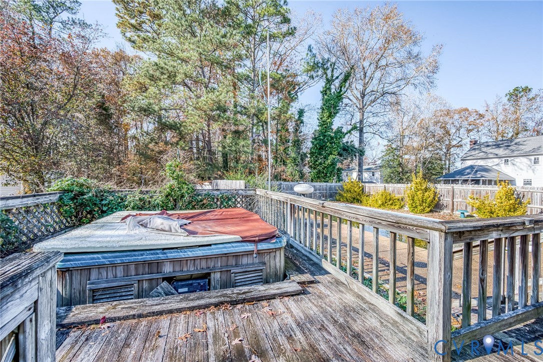 8910 Tunstall Road New Kent, VA 23124 - Photo 38 of 45 Wooden deck with a hot tub and a fenced backyard