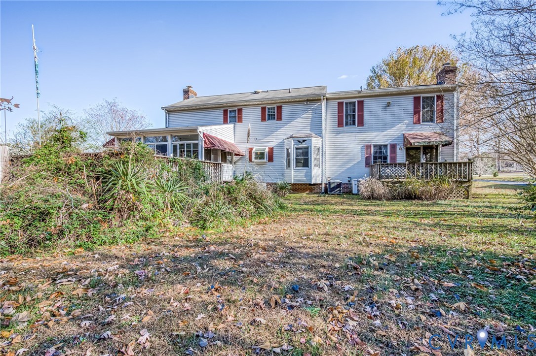 8910 Tunstall Road New Kent, VA 23124 - Photo 45 of 45 Back of property with a chimney, a deck, and a yar