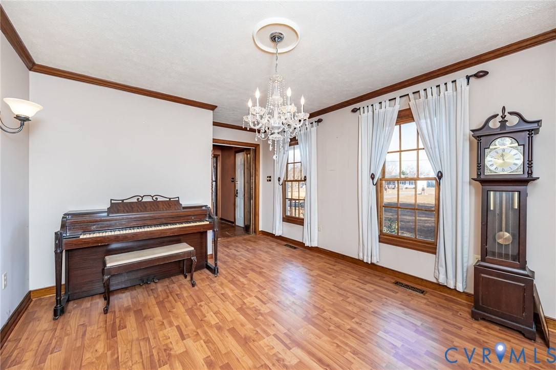 8910 Tunstall Road New Kent, VA 23124 - Photo 9 of 45 Sitting room with ornamental molding, light wood-s