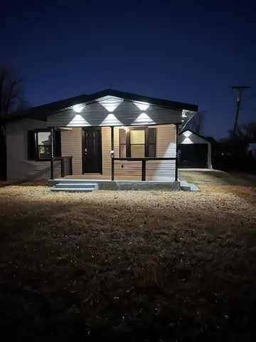 a view of an empty room with kitchen