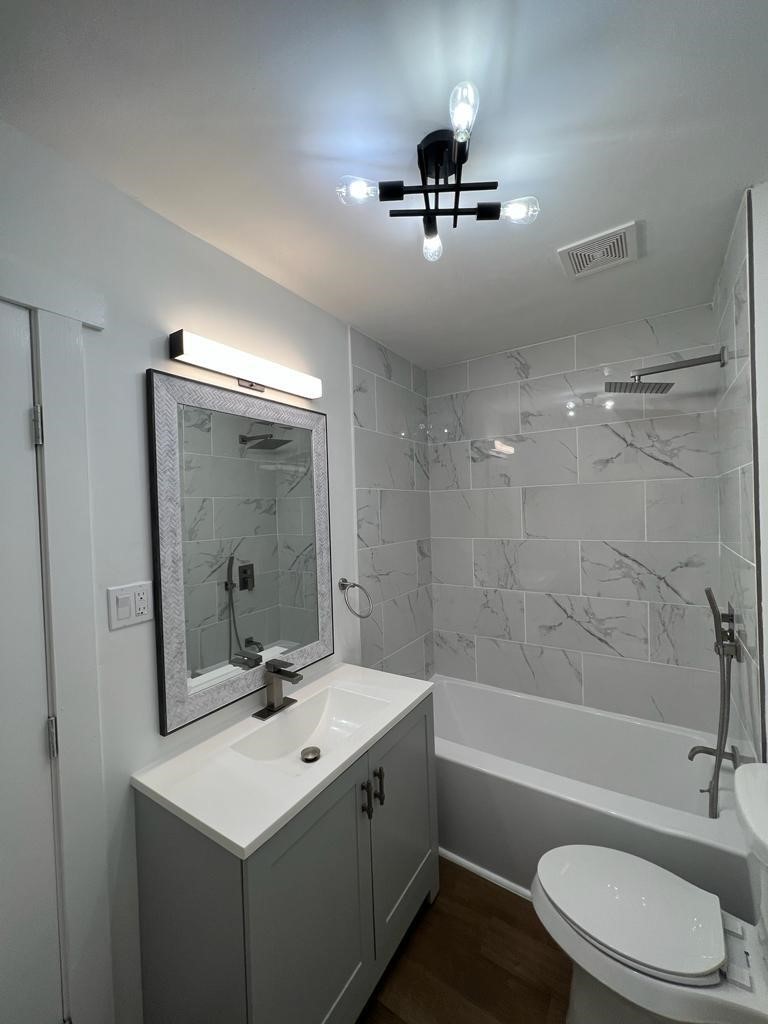 111 Second Street McLean, TX 79057 - Photo 2 of 7 a bathroom with a sink toilet a mirror and bathtub