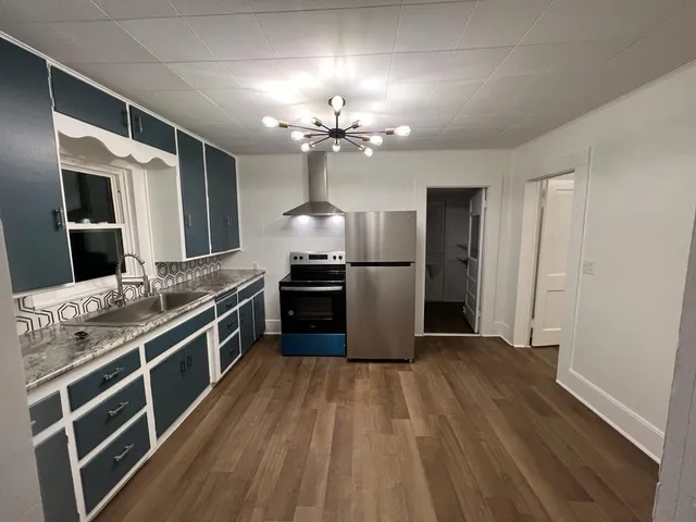 a kitchen with stainless steel appliances a refrigerator and a stove top oven