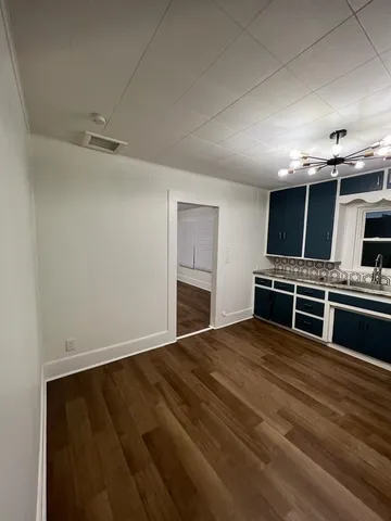 a view of kitchen with sink and microwave