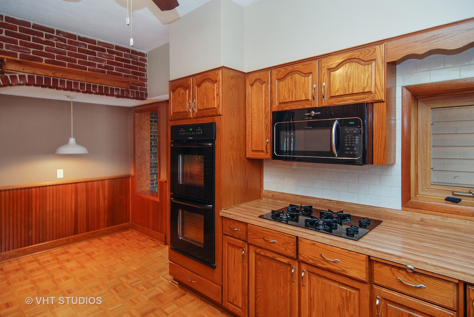 407 Longcommon Road Riverside, IL 60546 - Photo 5 of 22 a kitchen with stainless steel appliances granite countertop a stove and a microwave