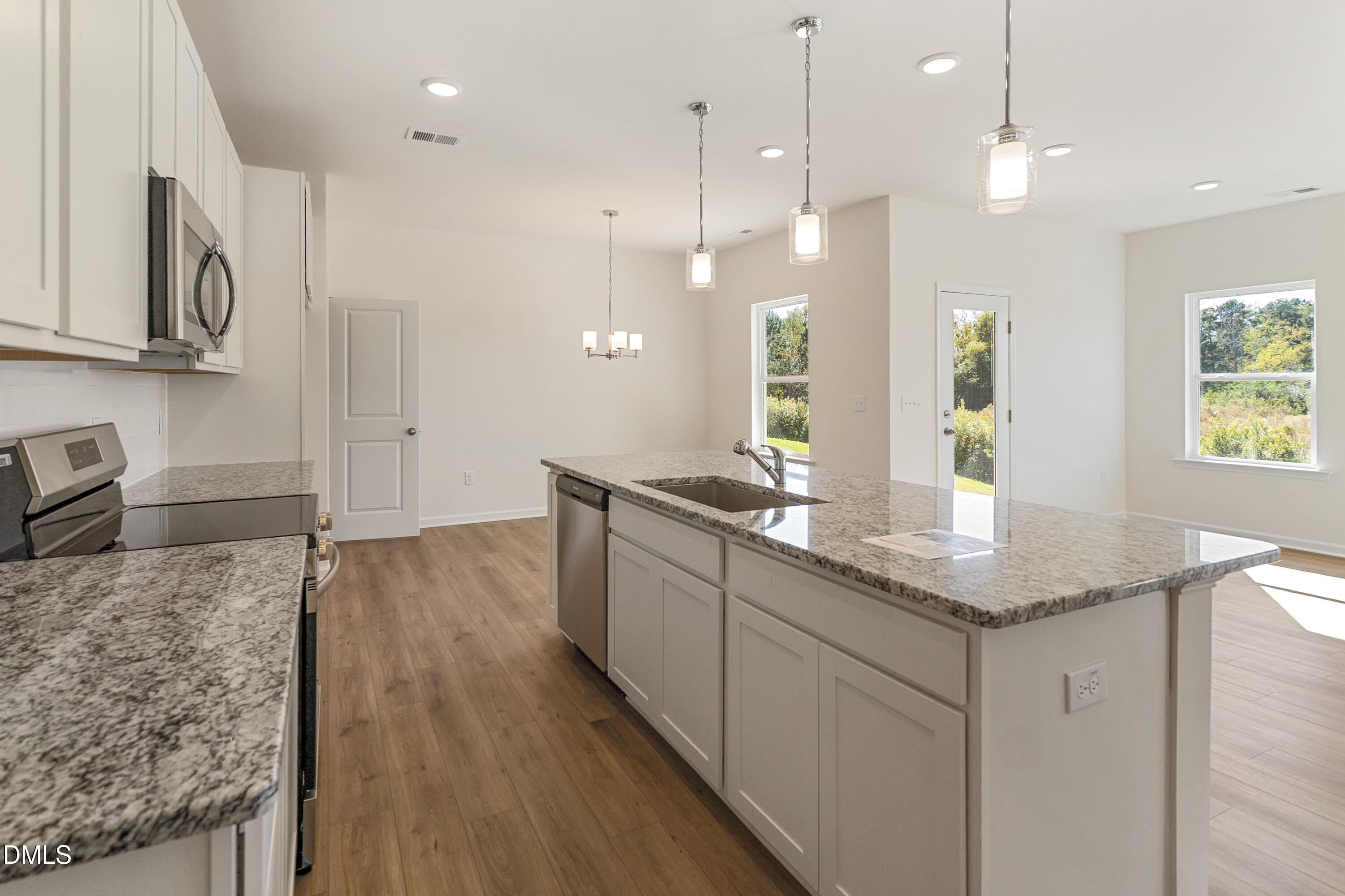 173 Courtside Drive Dunn, NC 28334 - Photo 4 of 24 a kitchen with stainless steel appliances granite countertop a sink a stove and a wooden floors