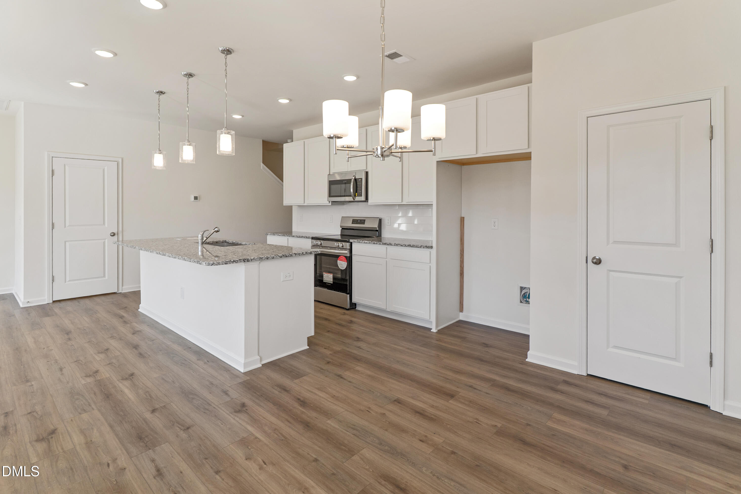 173 Courtside Drive Dunn, NC 28334 - Photo 5 of 24 a large kitchen with cabinets wooden floor and stainless steel appliances