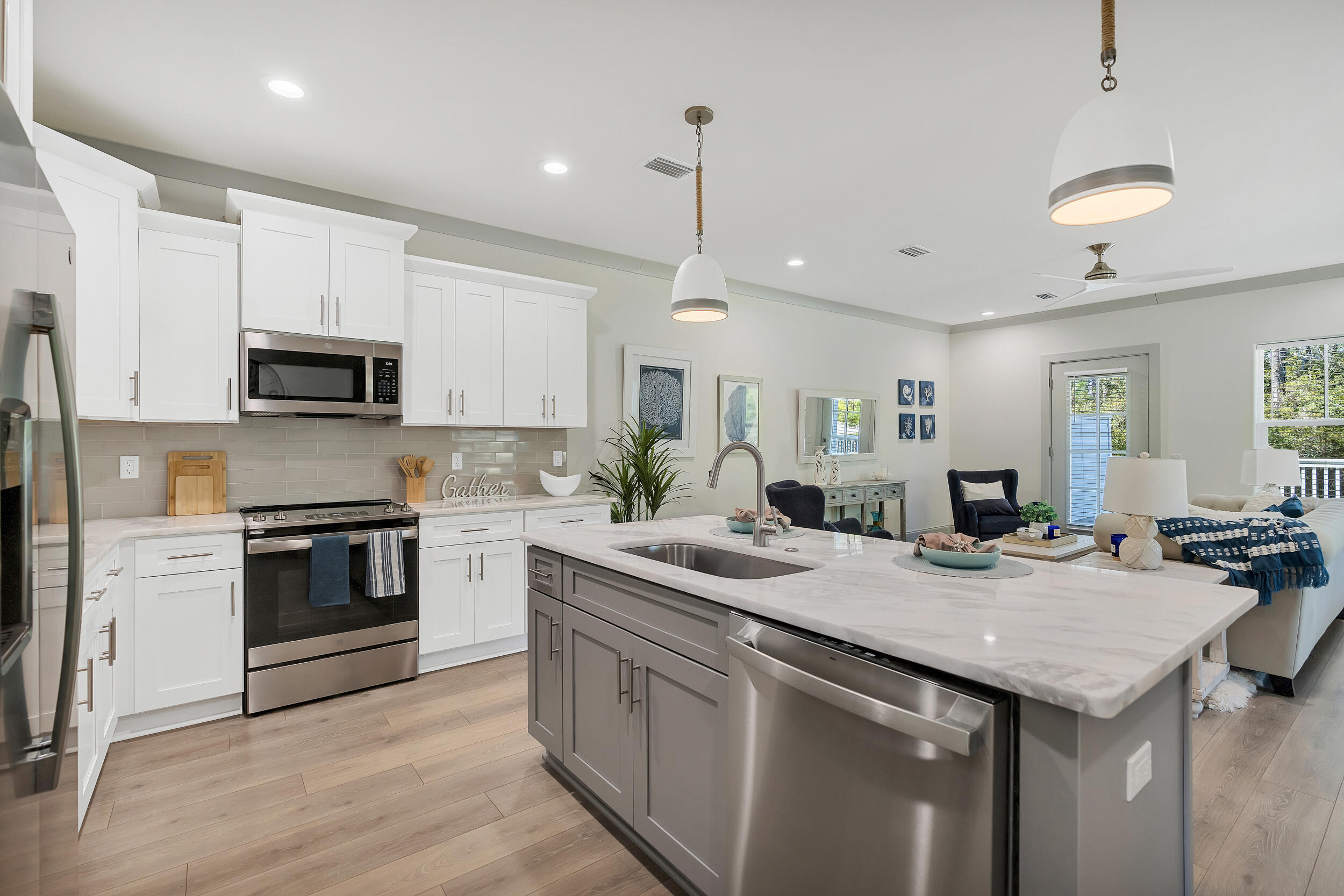 35 Golden Bell Ct Inlet Beach, Unit 35A Inlet Beach, FL 32461 - Photo 11 of 47 a kitchen with a sink and a stove top oven with wooden floor
