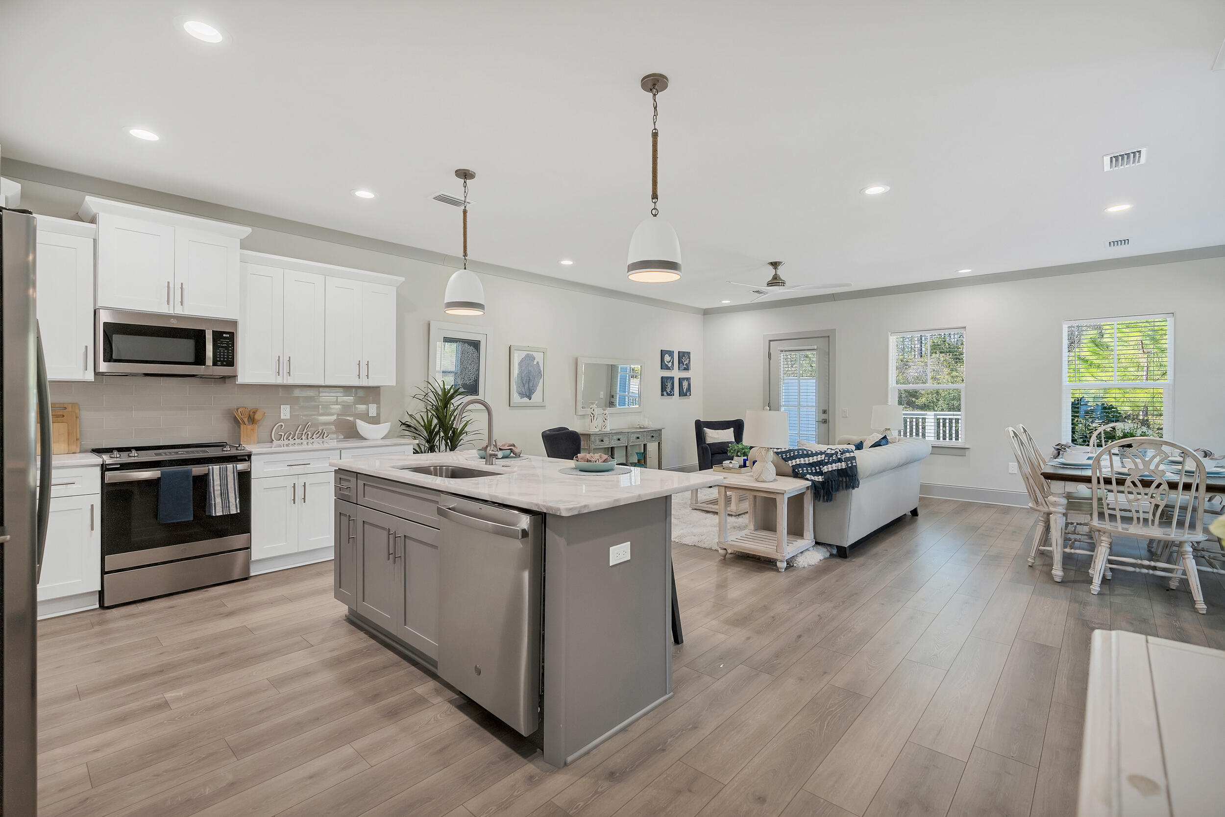 35 Golden Bell Ct Inlet Beach, Unit 35A Inlet Beach, FL 32461 - Photo 9 of 47 a open kitchen with stainless steel appliances granite countertop a stove top oven a sink dishwasher a dining table and chairs with wooden floor