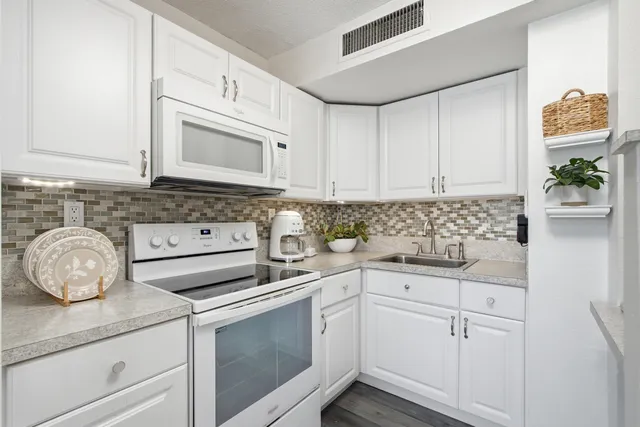 a kitchen that has a table and chairs in it