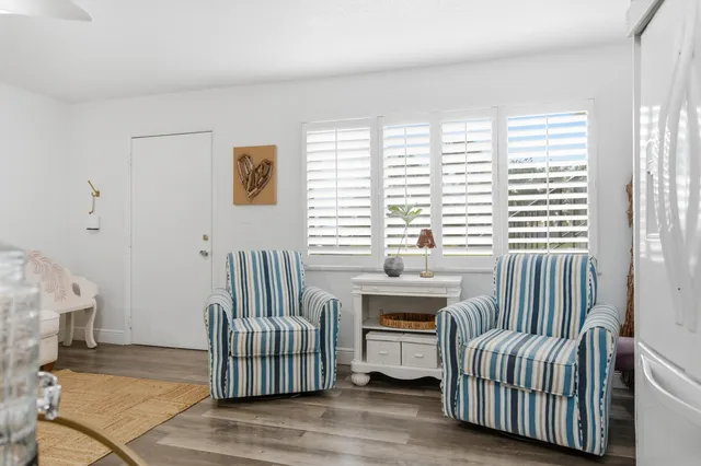 a kitchen with a refrigerator a stove top oven a counter space and wooden floor