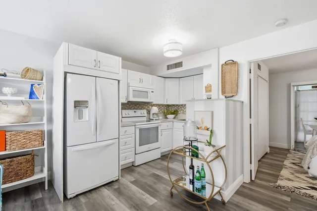 a living room with furniture and a kitchen view