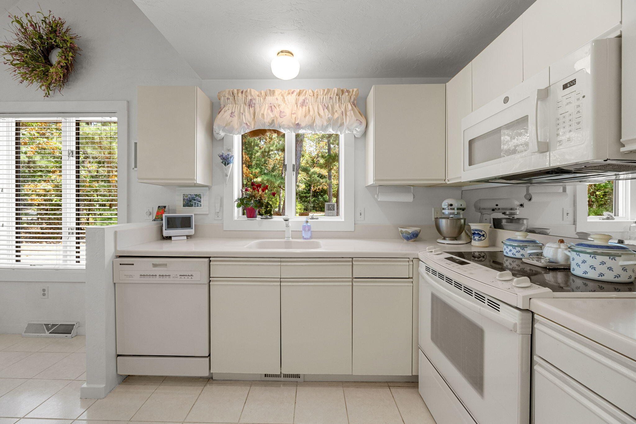 49 Shellback Way, Unit G Mashpee, MA 02649 - Photo 11 of 48 a kitchen with cabinets appliances a sink and a window