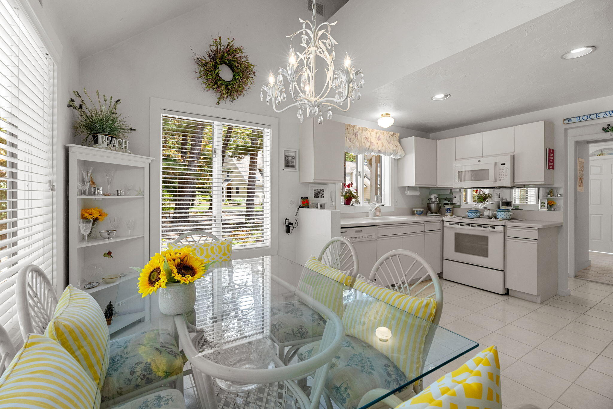 49 Shellback Way, Unit G Mashpee, MA 02649 - Photo 15 of 48 a kitchen with stainless steel appliances granite countertop a stove a refrigerator a sink a dining table and chairs with wooden floor