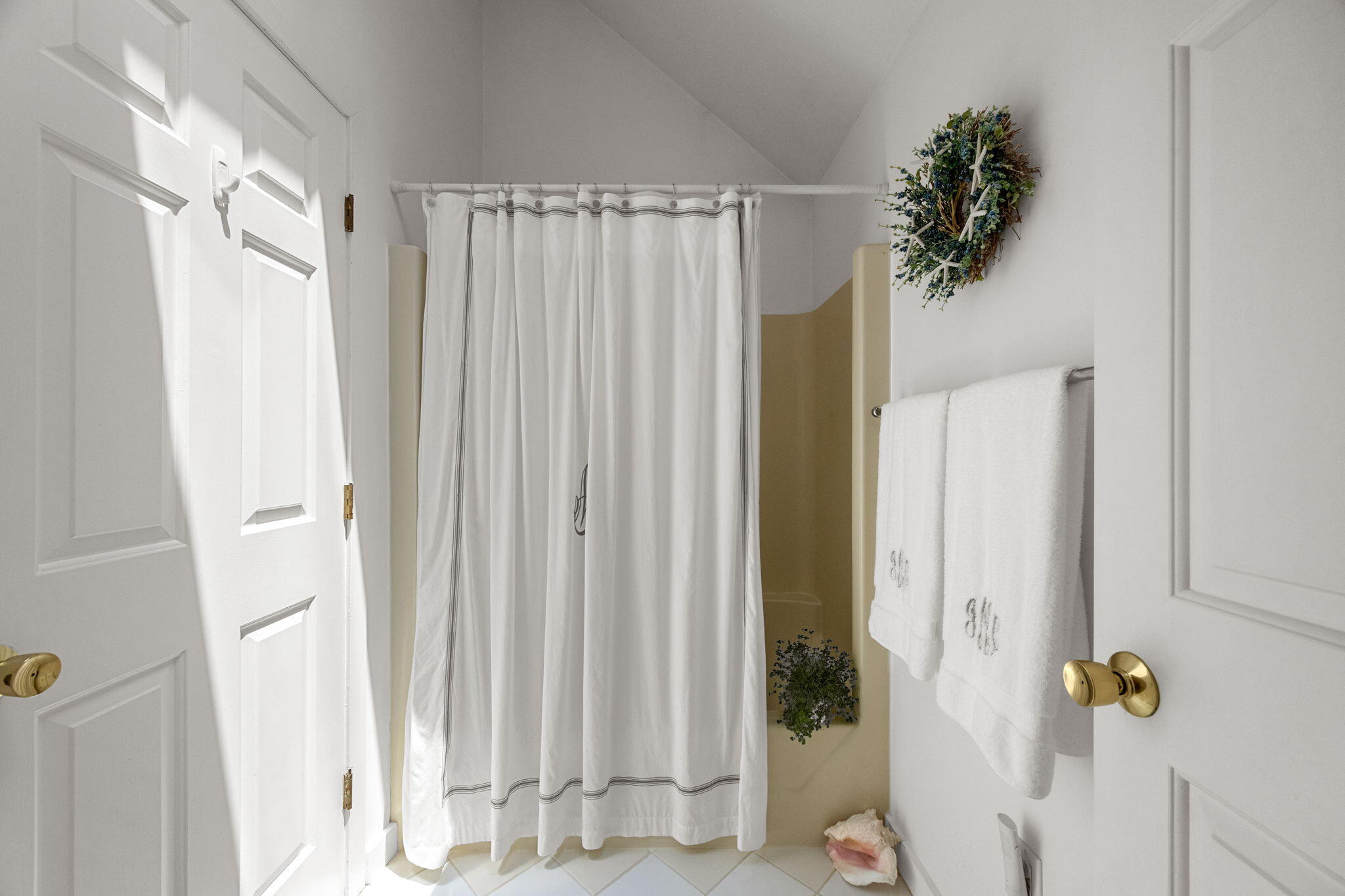 49 Shellback Way, Unit G Mashpee, MA 02649 - Photo 18 of 48 a view of a bathroom with a shower curtain