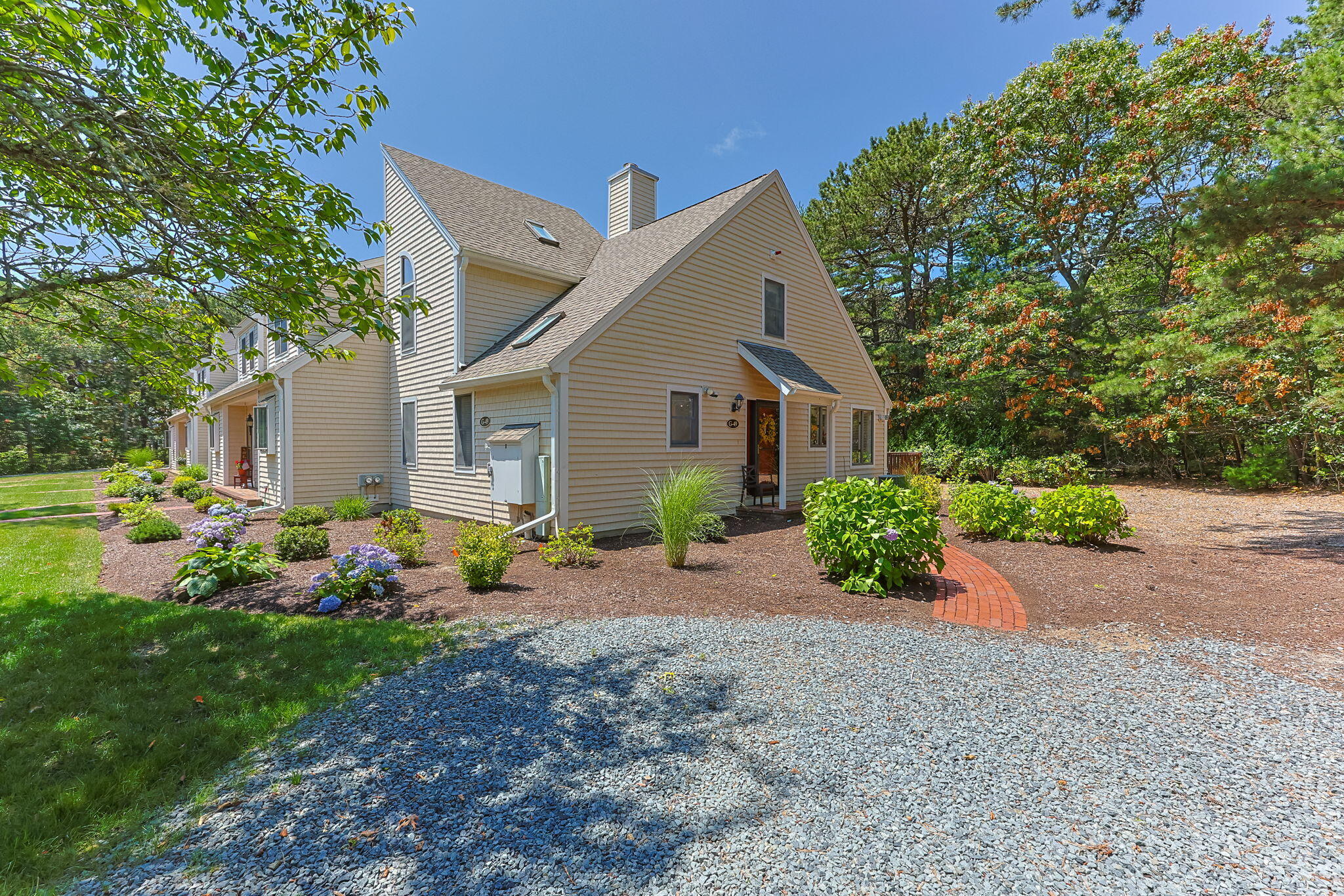 49 Shellback Way, Unit G Mashpee, MA 02649 - Photo 2 of 48 a front view of a house with garden