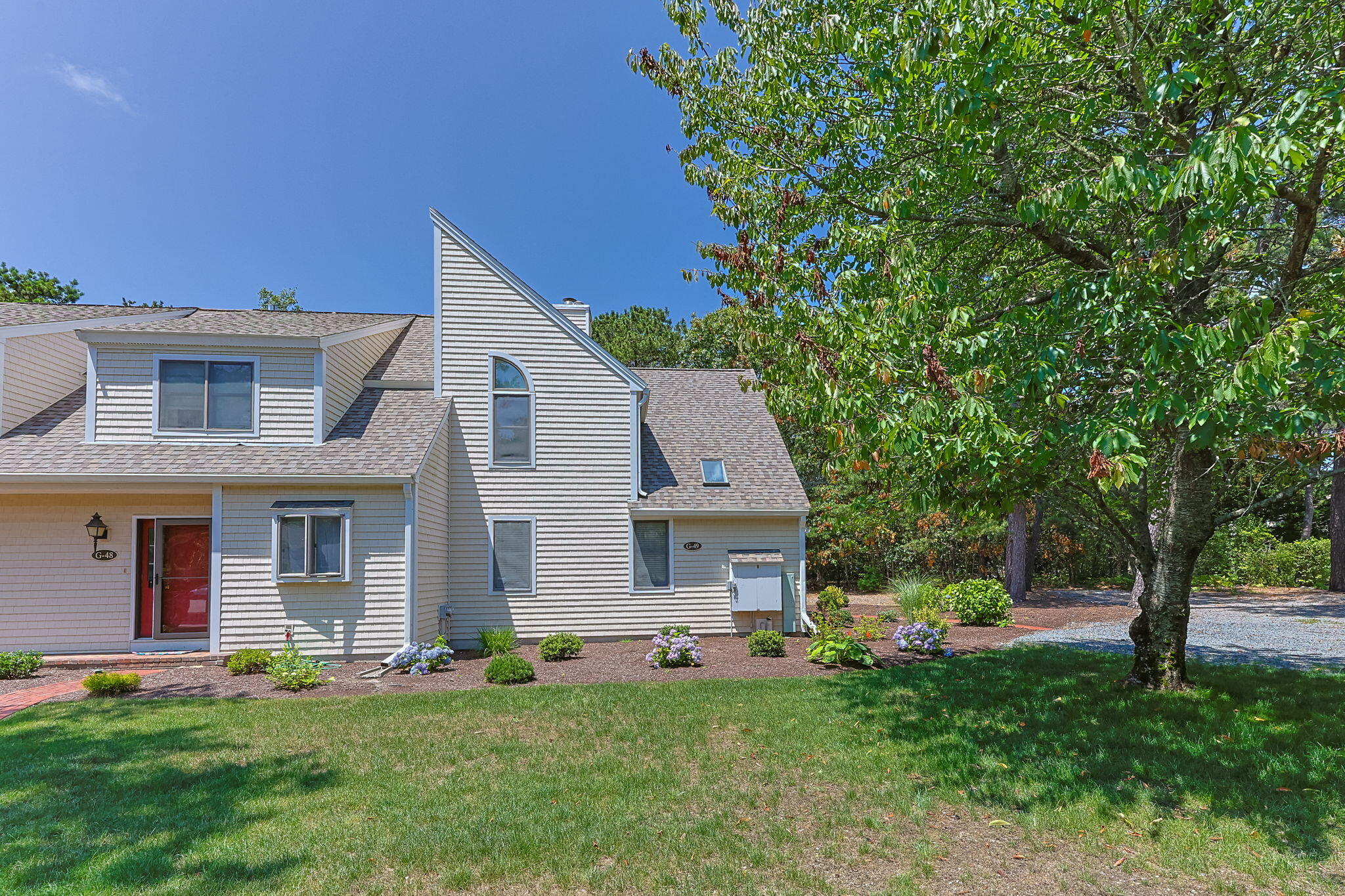 49 Shellback Way, Unit G Mashpee, MA 02649 - Photo 3 of 48 a front view of house with yard and green space