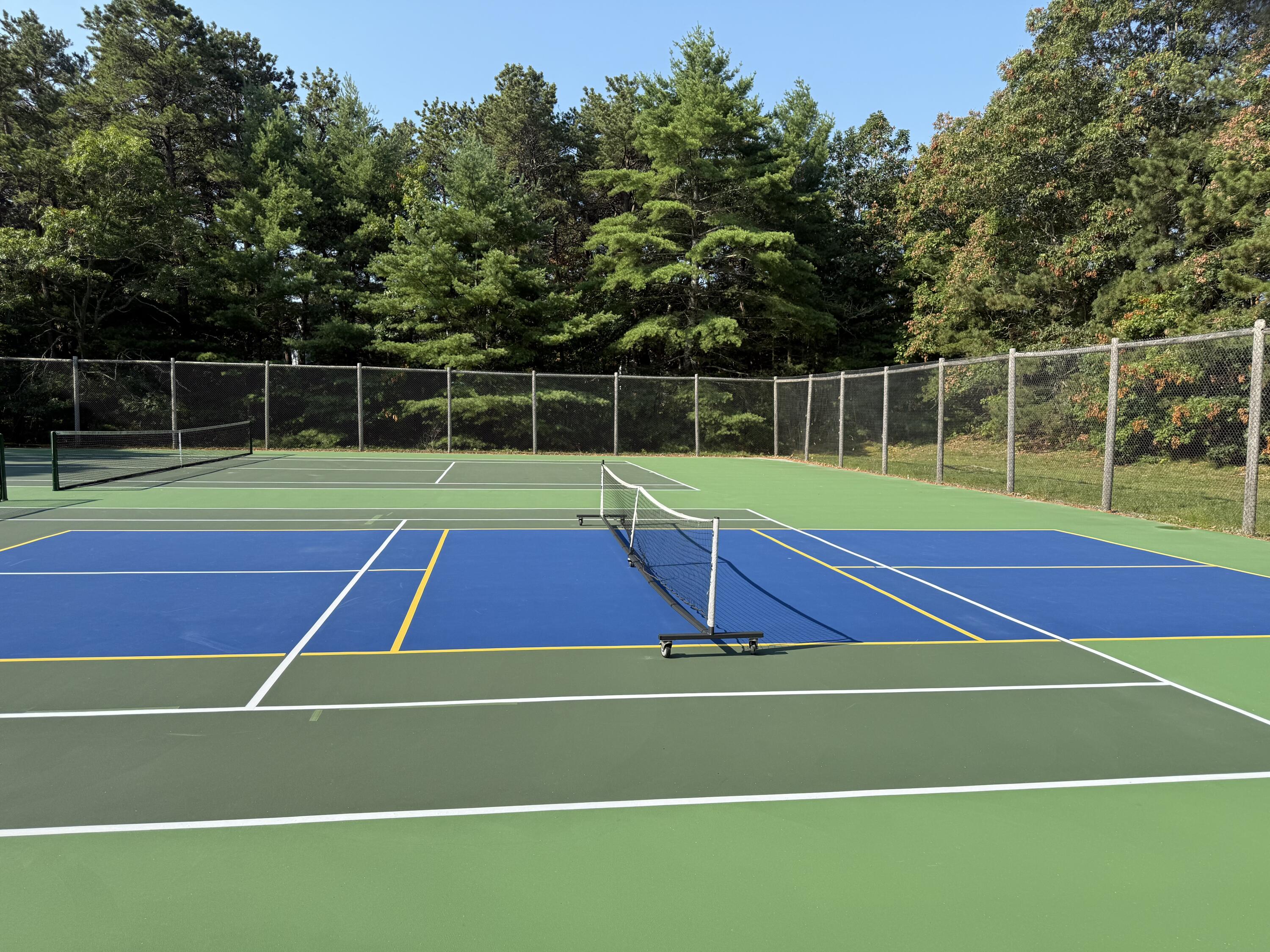 49 Shellback Way, Unit G Mashpee, MA 02649 - Photo 37 of 48 a tennis court with view of tall trees
