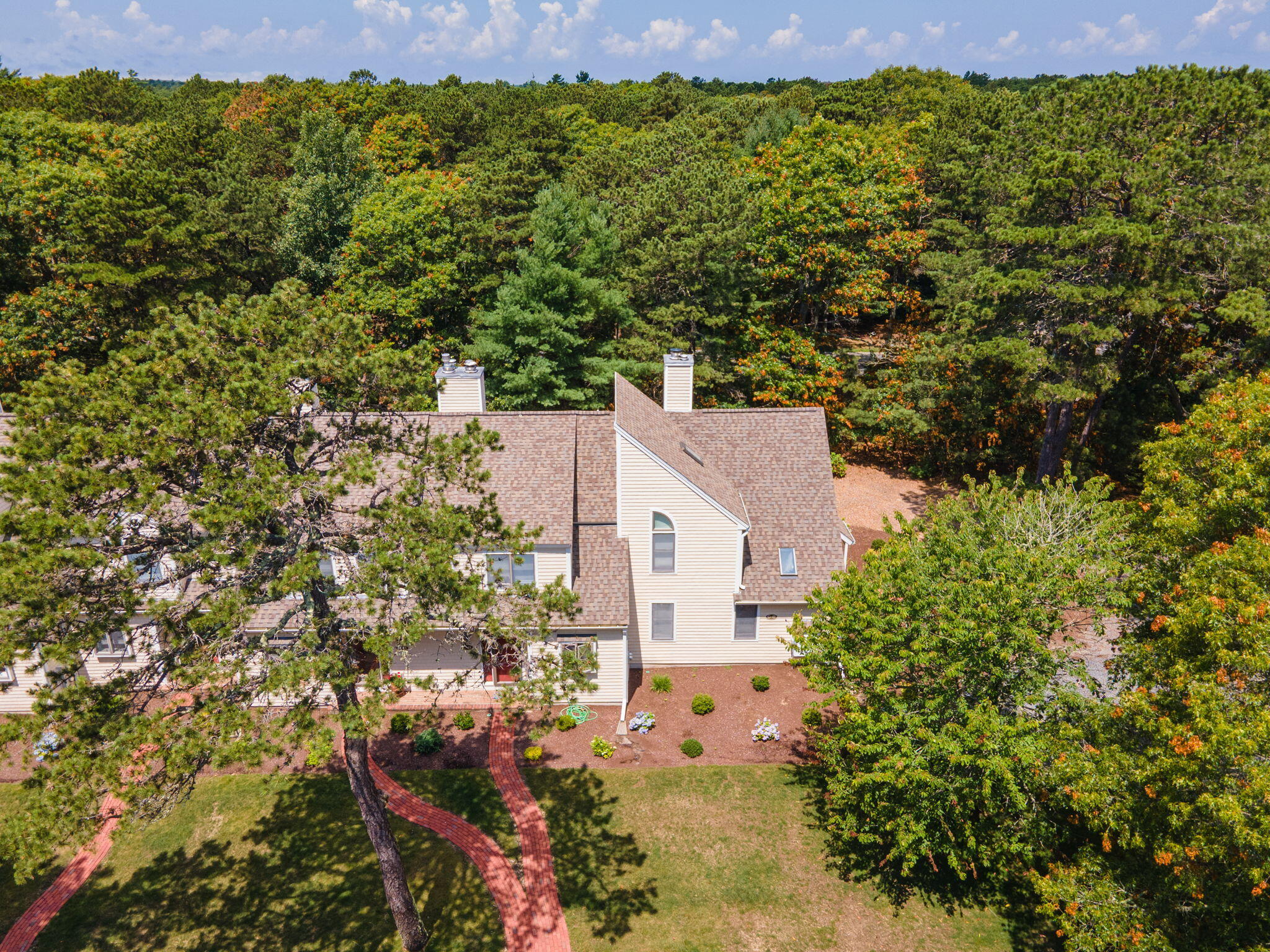 49 Shellback Way, Unit G Mashpee, MA 02649 - Photo 41 of 48 a view of a big yard with plants and large trees
