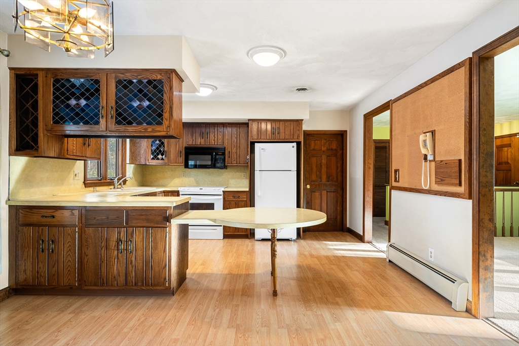 26 Nottingham Drive Raynham, MA 02767 - Photo 14 of 42 a kitchen with stainless steel appliances wooden floor and refrigerator