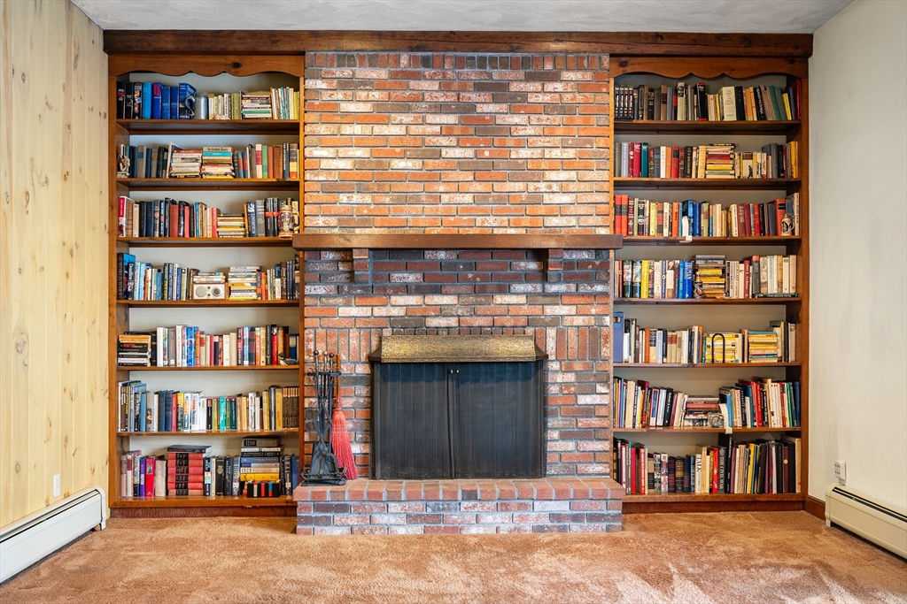 26 Nottingham Drive Raynham, MA 02767 - Photo 18 of 42 a living room with bookshelf and a book shelf