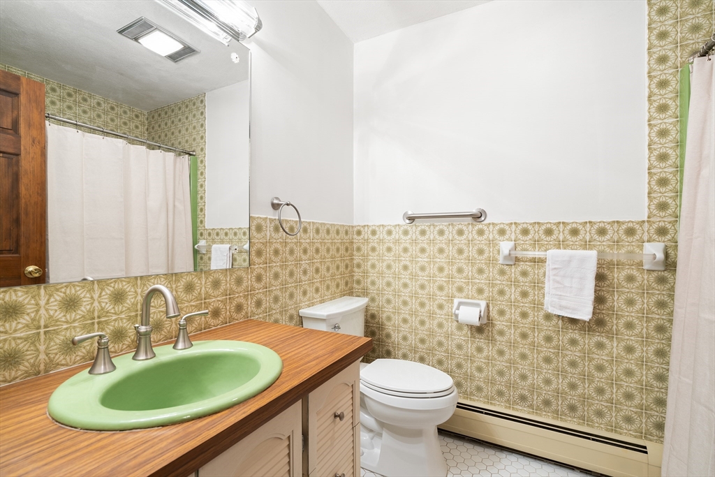26 Nottingham Drive Raynham, MA 02767 - Photo 31 of 42 a bathroom with a granite countertop sink and a mirror