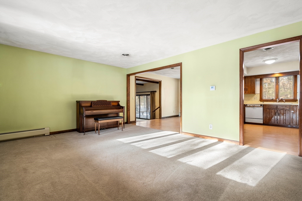 26 Nottingham Drive Raynham, MA 02767 - Photo 8 of 42 a living room with furniture and a large window