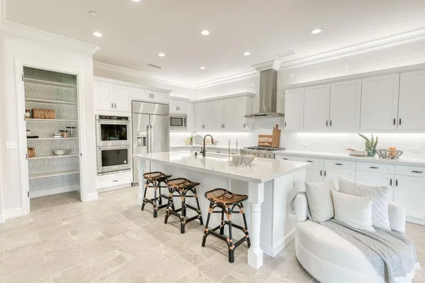a kitchen with stainless steel appliances kitchen island granite countertop a sink and cabinets