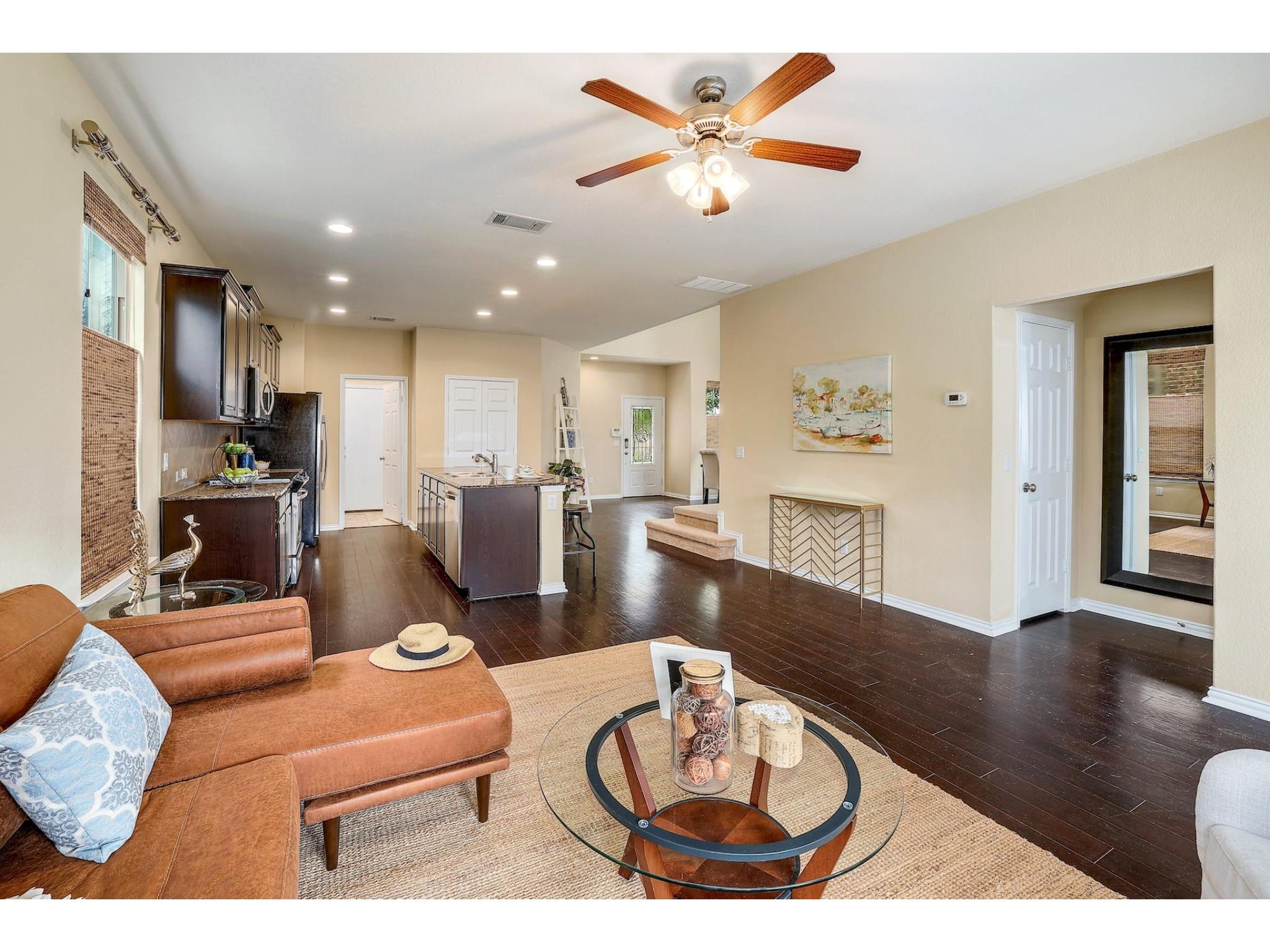 16021 Travesia Way Austin, TX 78728 - Photo 11 of 27 a living room with furniture kitchen view and a wooden floor
