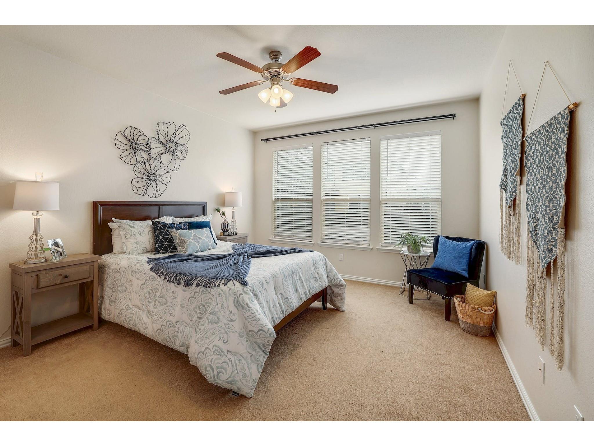 16021 Travesia Way Austin, TX 78728 - Photo 13 of 27 a bed room with a bed and a chair