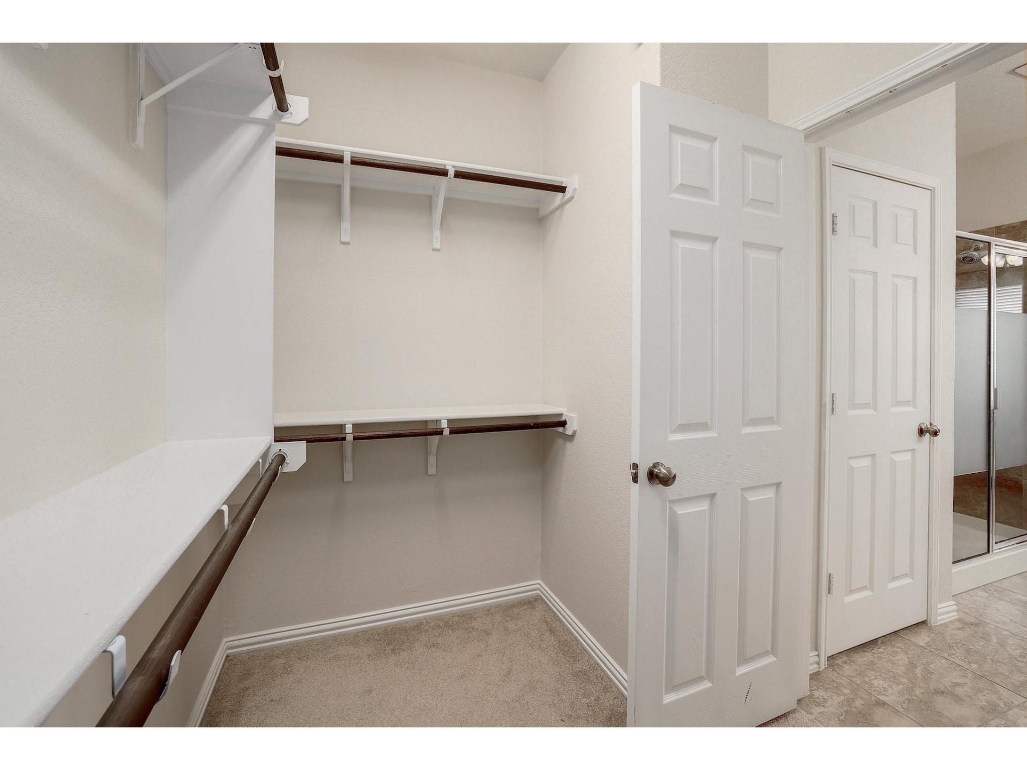 16021 Travesia Way Austin, TX 78728 - Photo 17 of 27 a view of walk in closet with empty racks