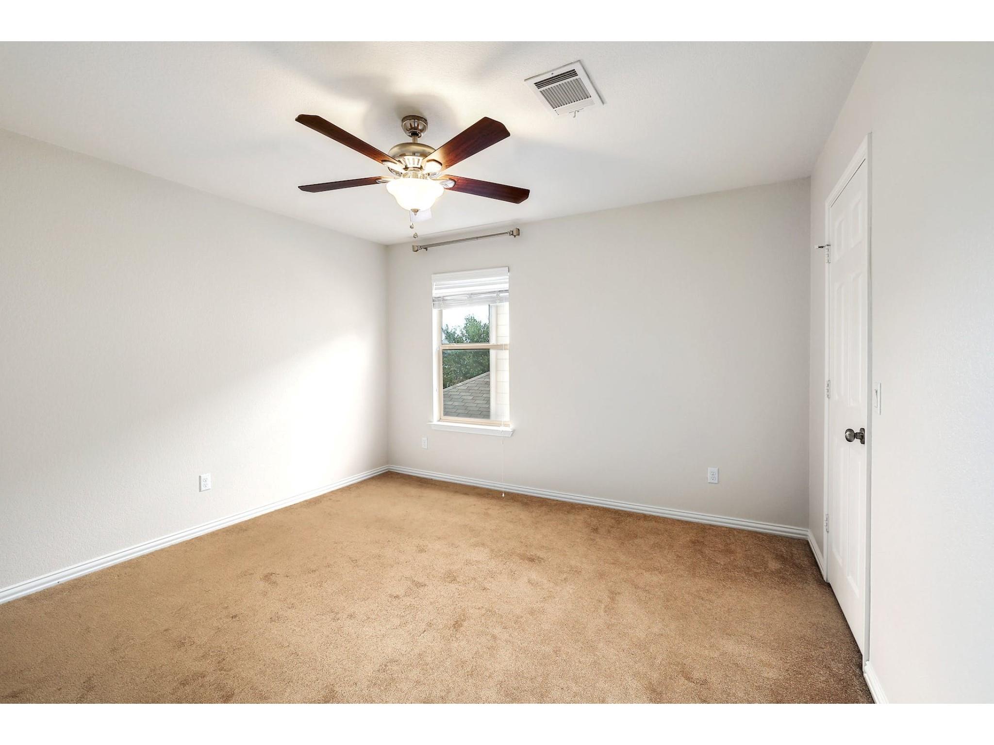 16021 Travesia Way Austin, TX 78728 - Photo 19 of 27 an empty room with windows and fan