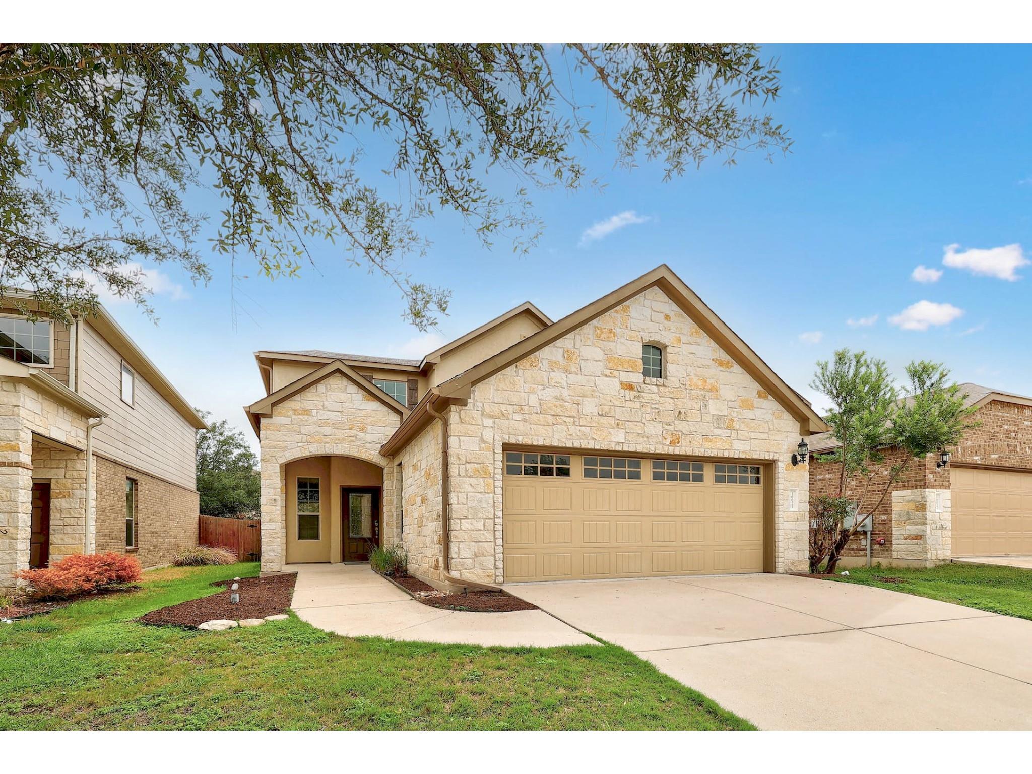 16021 Travesia Way Austin, TX 78728 - Photo 2 of 27 a front view of a house with a yard and garage